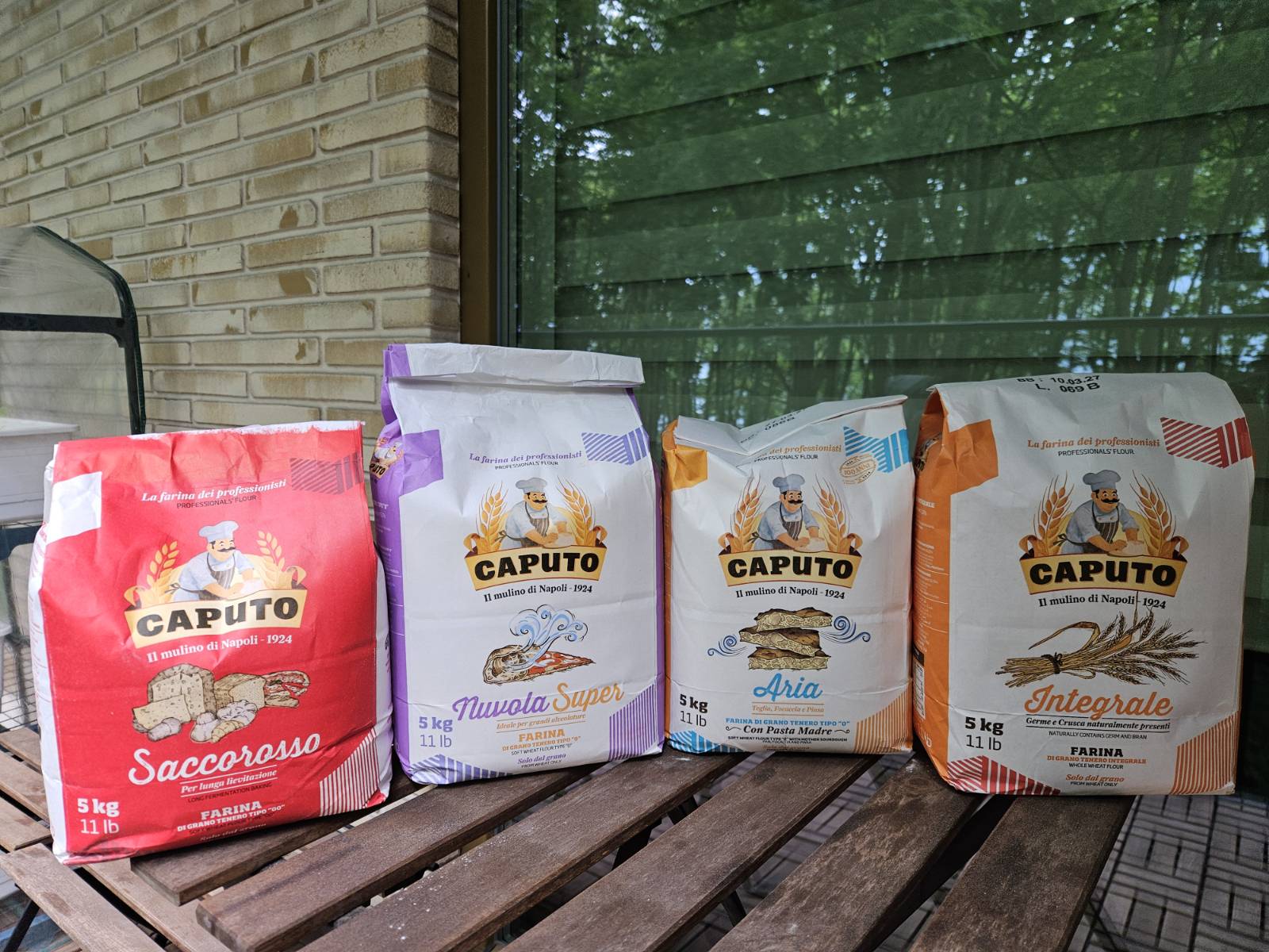 Four Caputo flour bags: Saccorosso, Nuvola Super, Aria, and Integrale